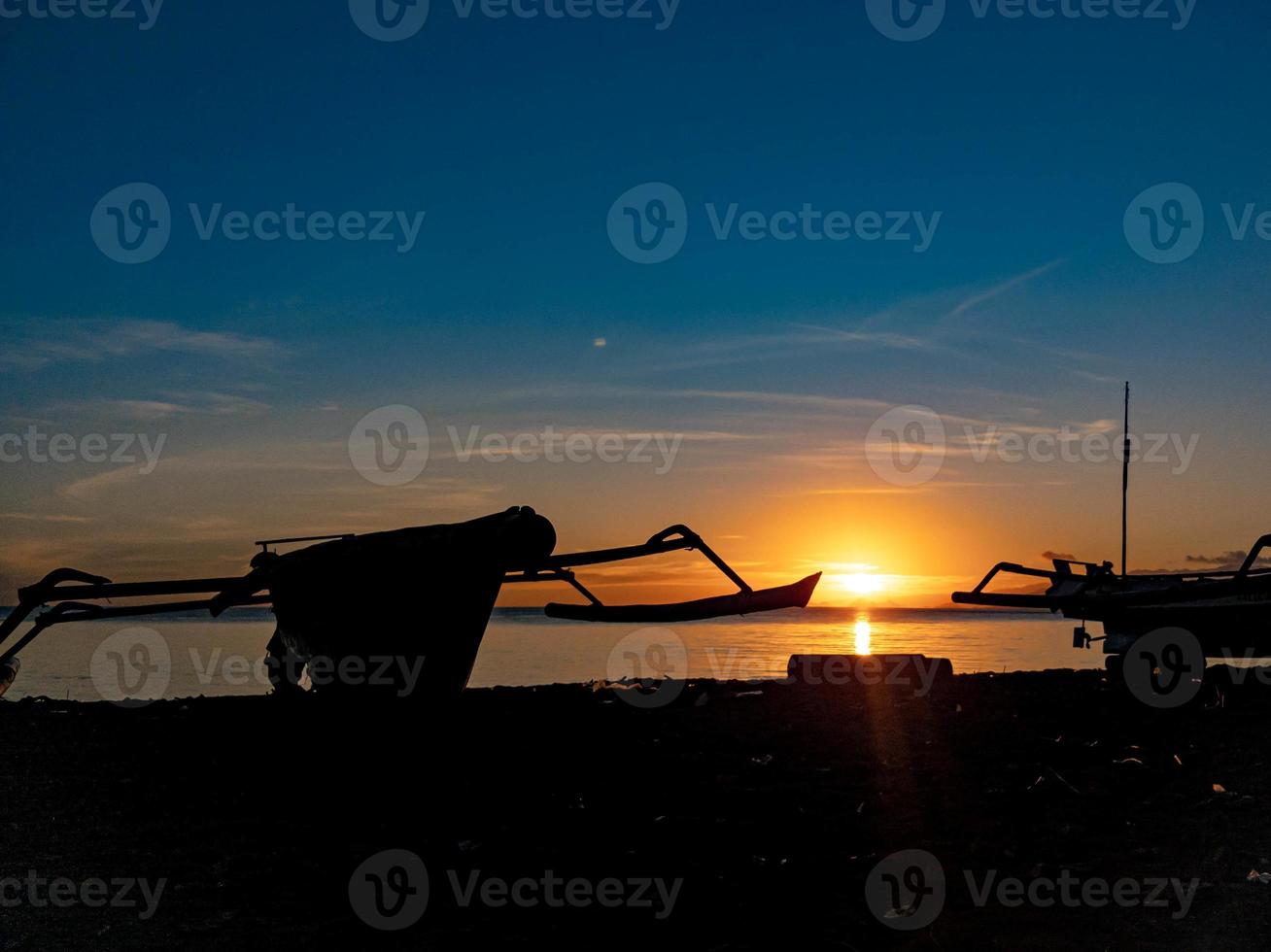 silhouette d'objets sur la plage avec le lever du soleil photo