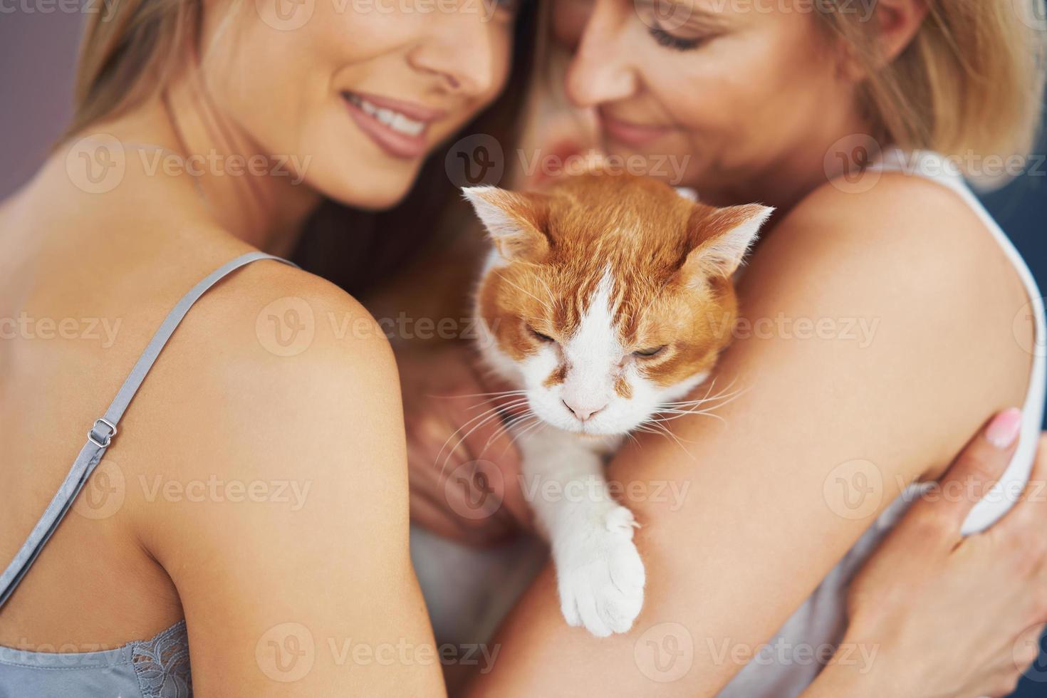 belles deux filles adultes dans la maison avec un chat photo