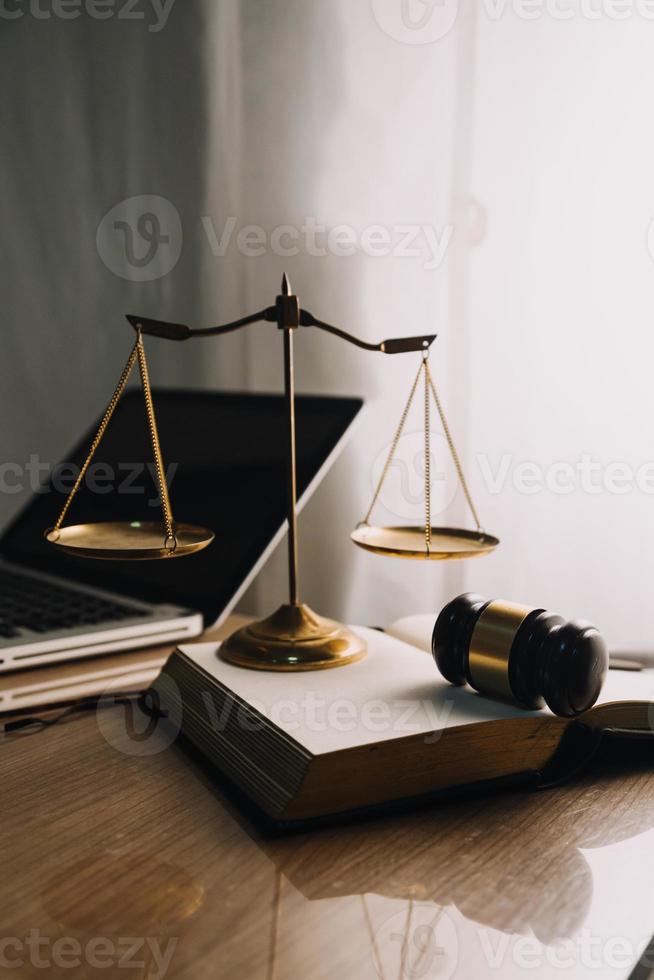 concept de justice et de droit. juge masculin dans une salle d'audience avec le marteau, travaillant avec, clavier d'ordinateur et d'accueil, lunettes, sur table à la lumière du matin photo