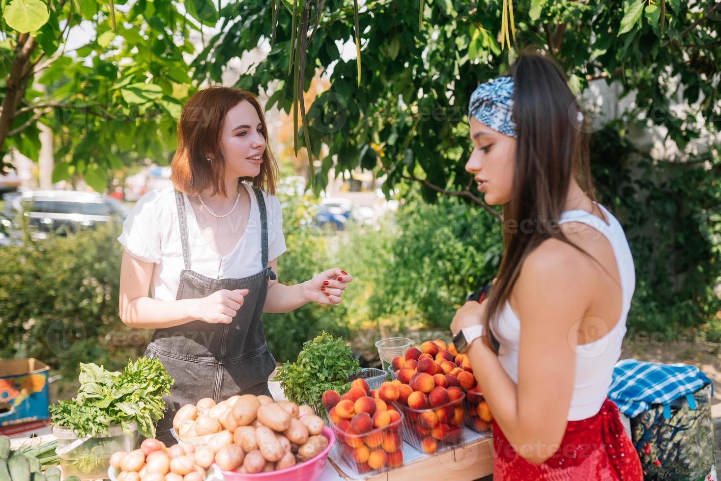 la vendeuse propose un marché de producteurs de légumes frais et biologiques. photo