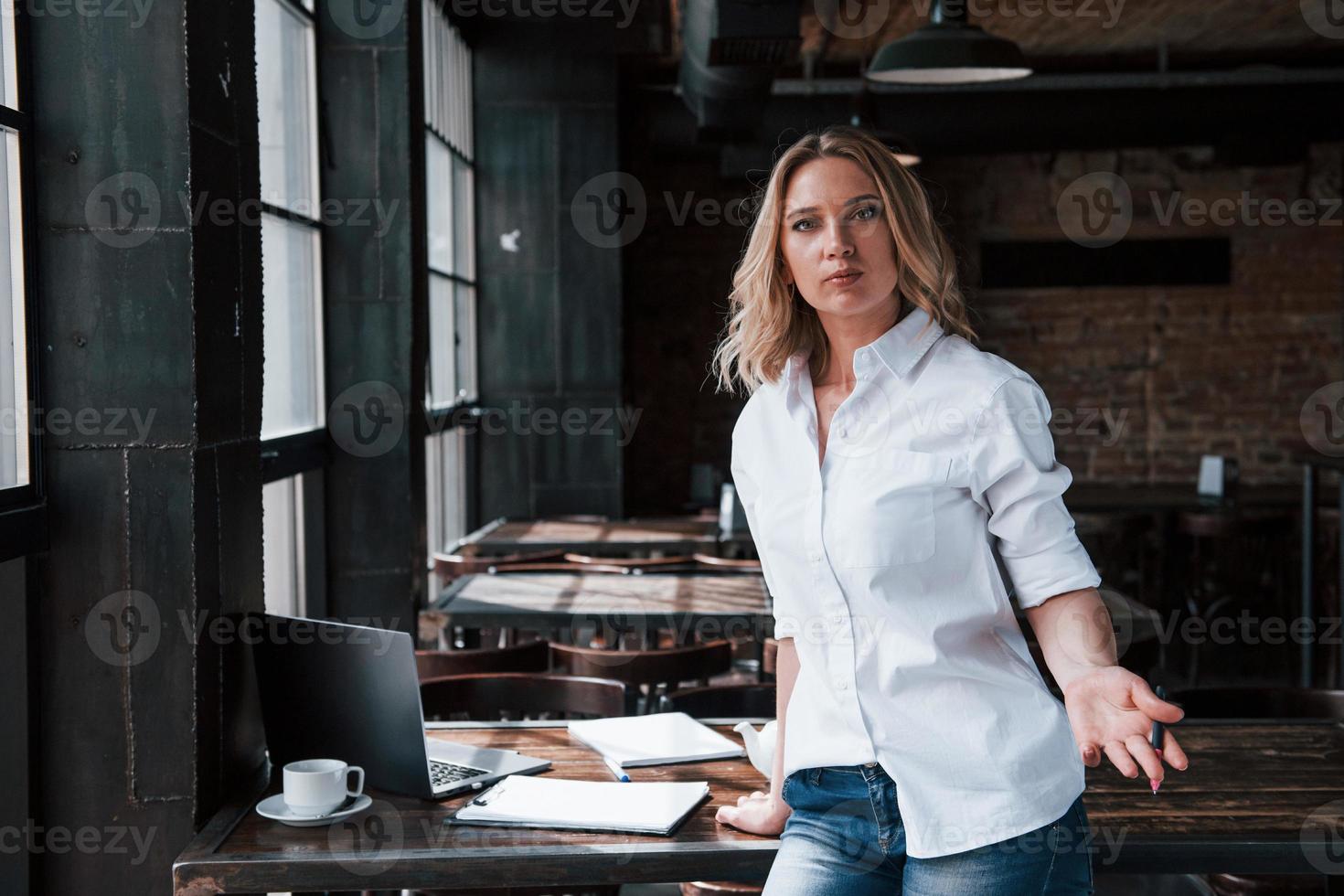 femme psychologue professionnelle. femme d'affaires aux cheveux blonds bouclés à l'intérieur dans un café pendant la journée photo