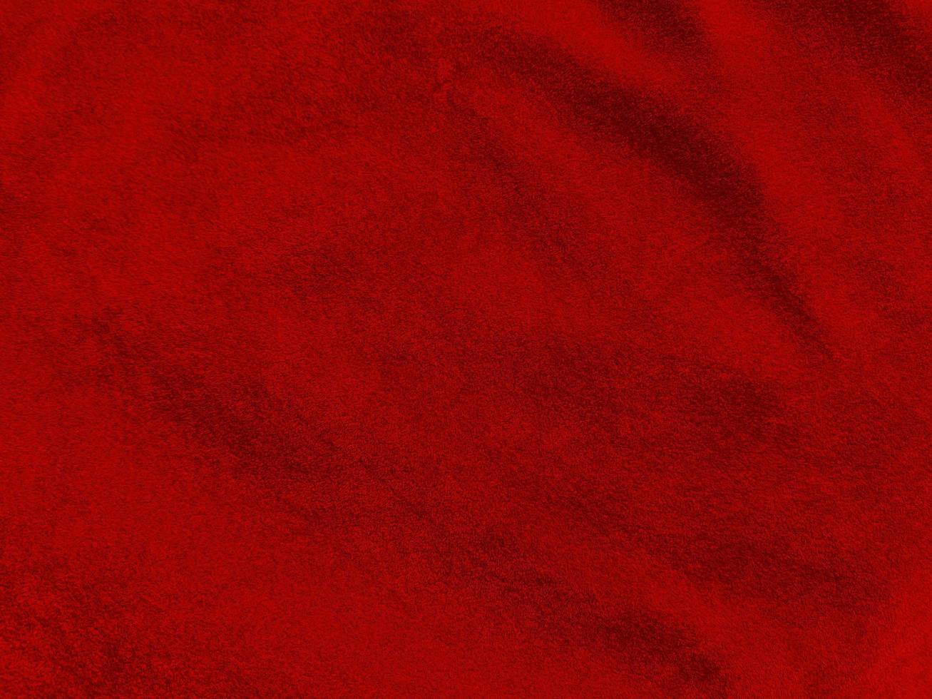 texture de tissu de velours rouge foncé utilisée comme arrière-plan. fond de tissu rouge foncé vide de matière textile douce et lisse. il y a de l'espace pour le texte.. photo