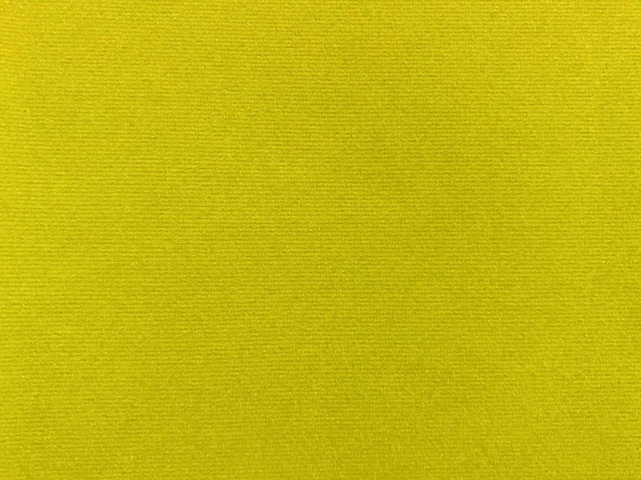 texture de tissu de velours jaune utilisée comme arrière-plan. fond de tissu jaune vide de matière textile douce et lisse. il y a de l'espace pour le texte.. photo