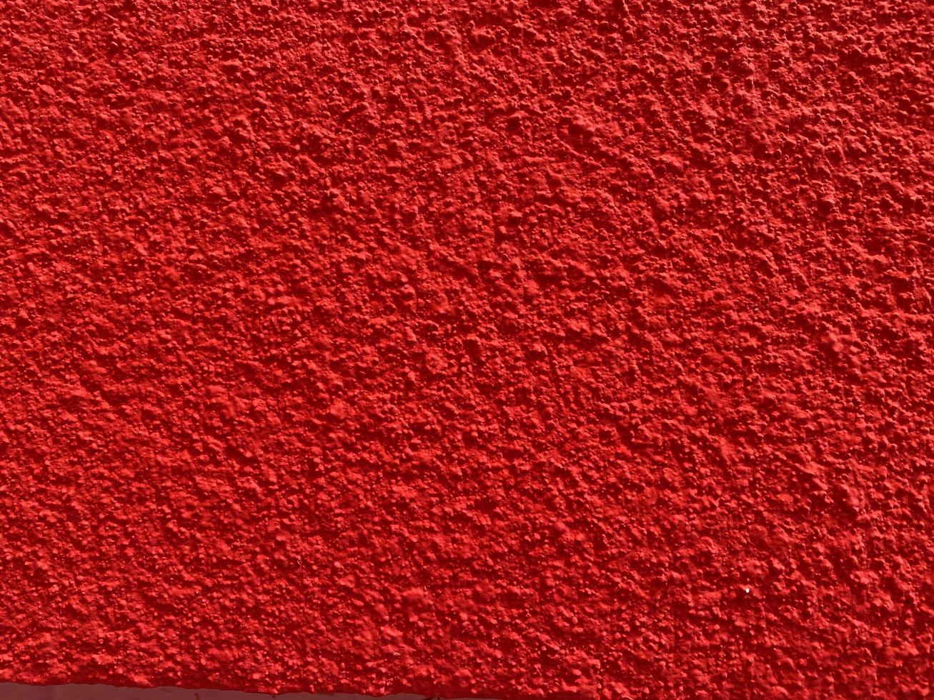 texture transparente du vieux mur de ciment rouge une surface rugueuse, avec un espace pour le texte, pour un arrière-plan. photo