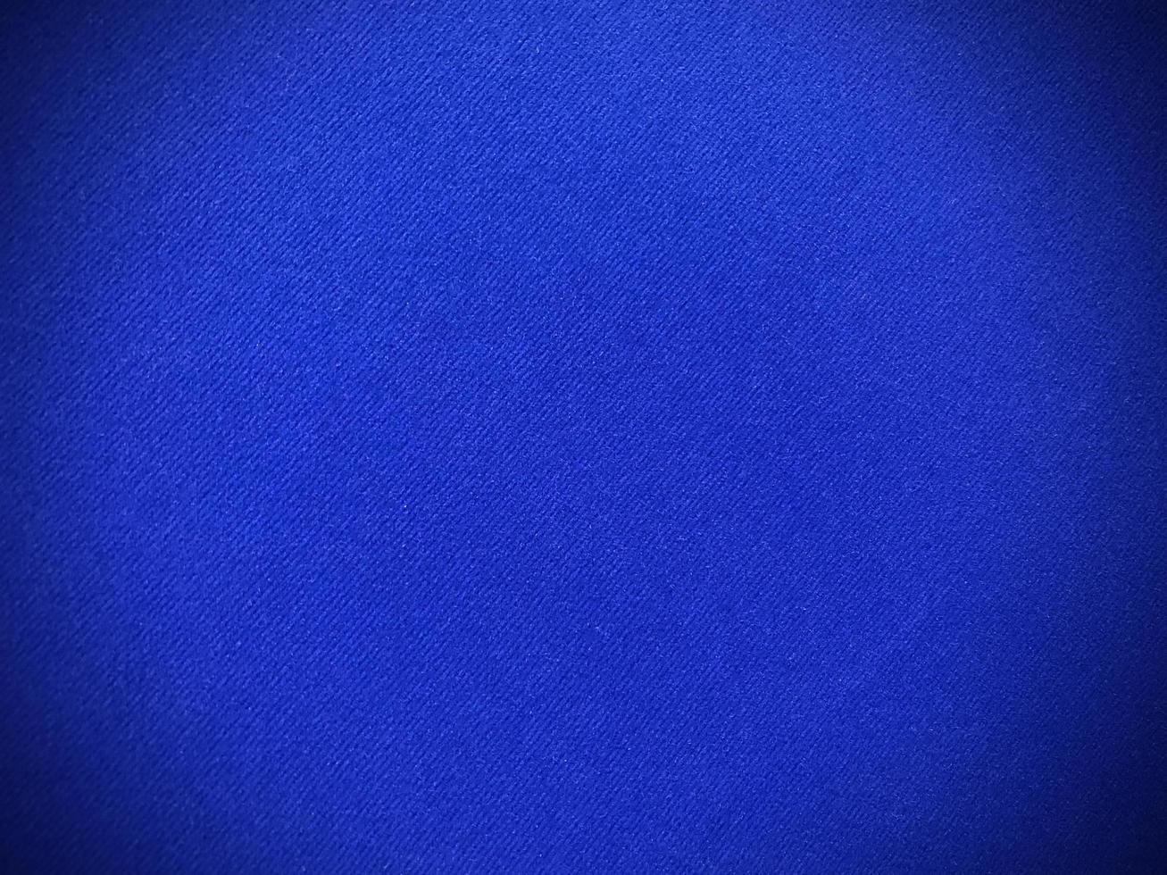 texture de tissu de velours bleu foncé utilisée comme arrière-plan. fond de tissu bleu foncé vide de matière textile douce et lisse. il y a de l'espace pour le texte.. photo