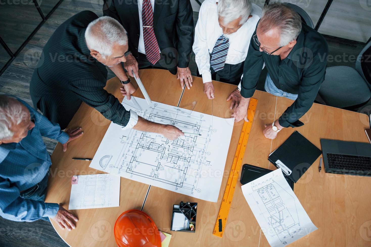 vue de dessus d'une équipe âgée d'architectes d'hommes d'affaires âgés se réunissant au bureau et travaillant avec le plan photo