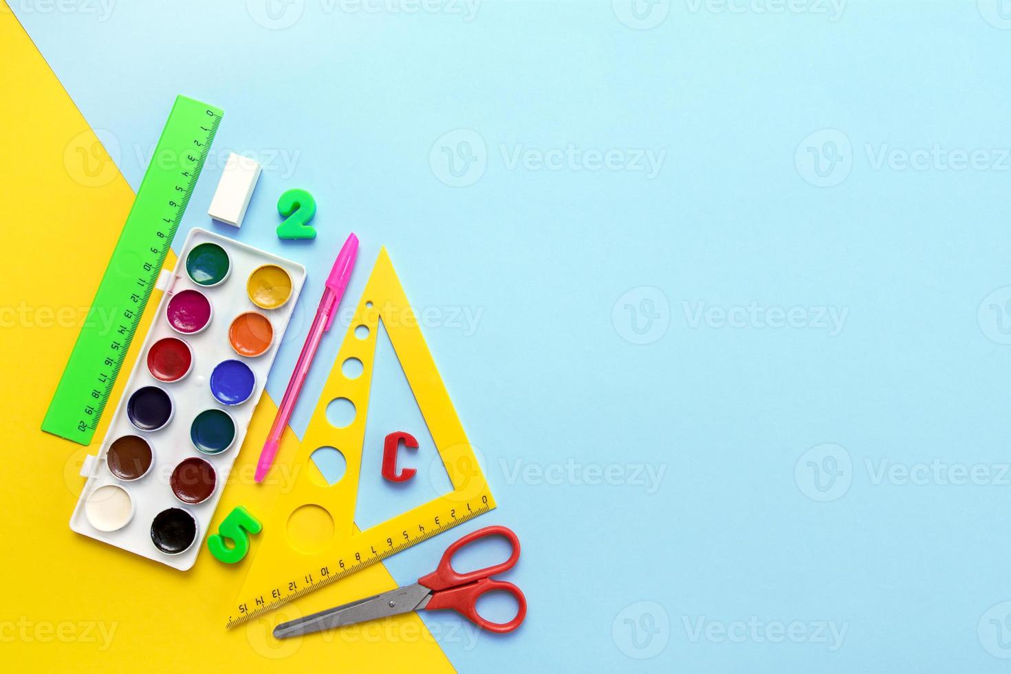 fournitures scolaires - triangle, règle, aquarelle, ciseaux sur fond jaune-bleu, espace copie, retour à l'école photo
