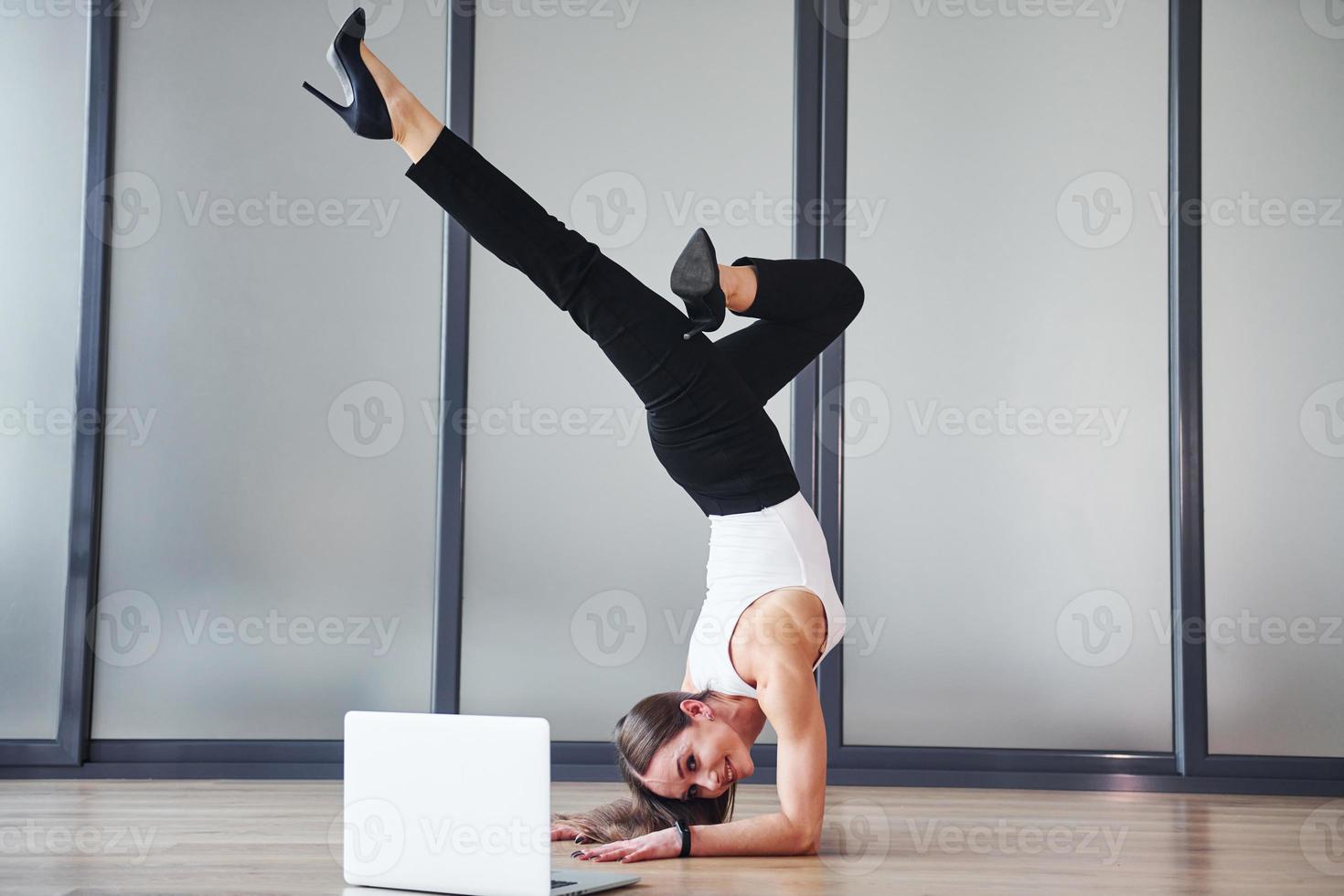 jeune femme adulte en vêtements formels est à l'intérieur sur fond gris photo