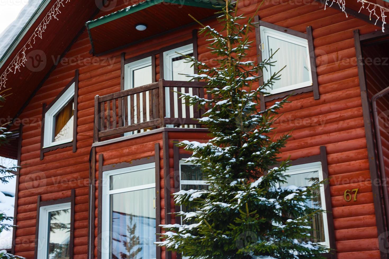 maison en bois dans la forêt d'hiver photo