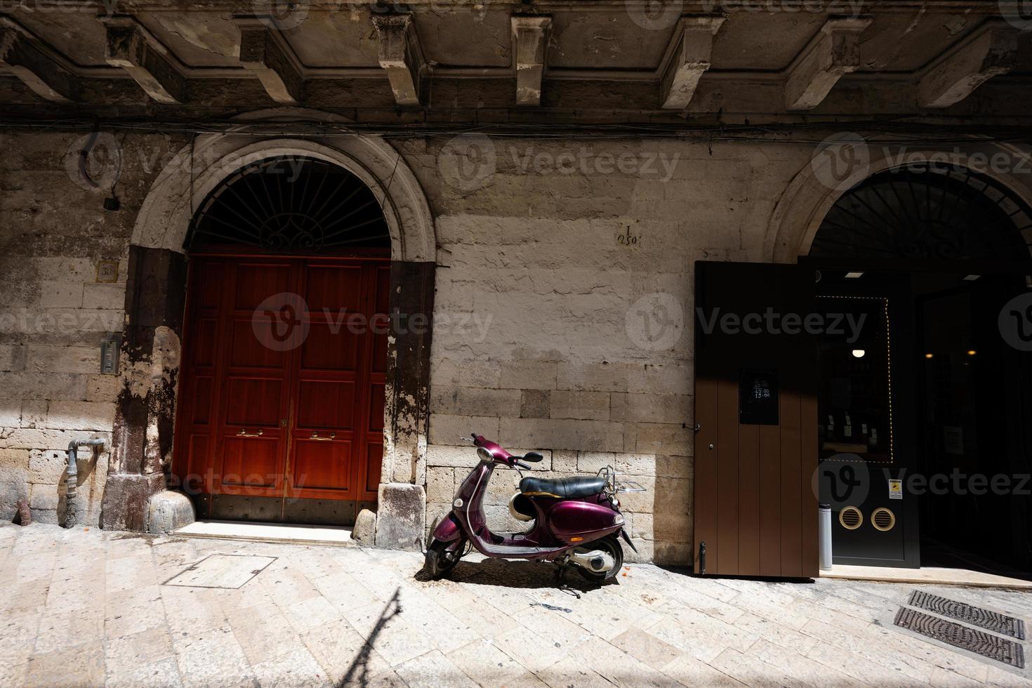 scooter debout dans la rue vide de la vieille ville italienne de bari, pouilles, italie du sud. photo