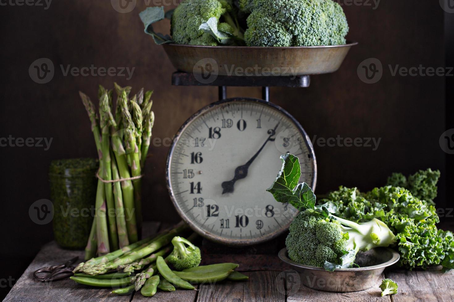 légumes verts frais sur de vieilles balances de cuisine photo