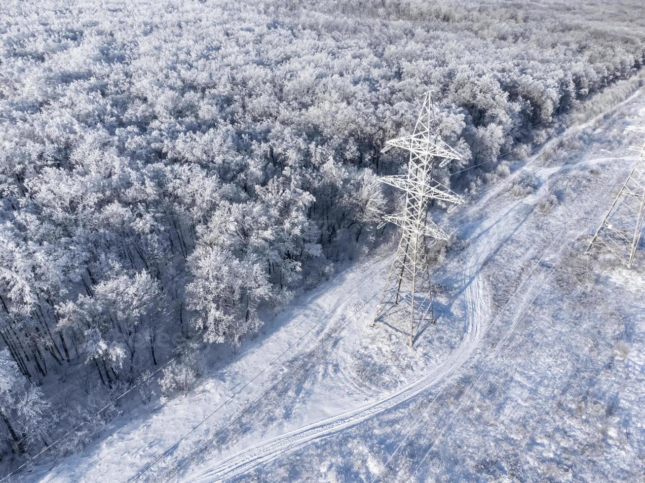 tour de transmission à haute tension dans la forêt d'hiver. photo