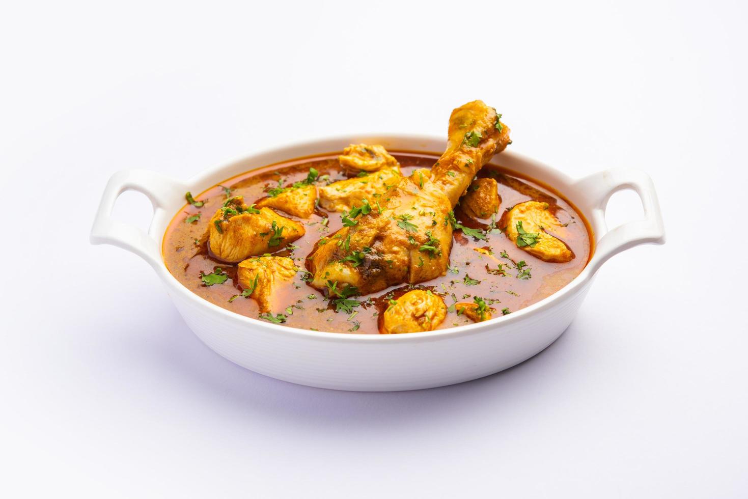 curry de poulet rouge ou murgh masala ou korma avec un morceau de cuisse proéminent photo