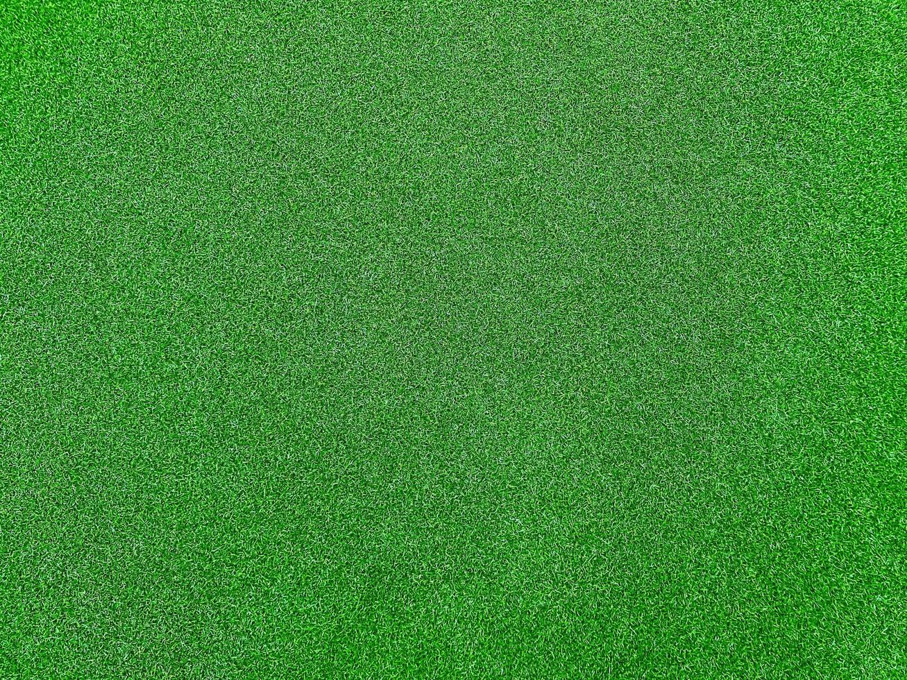 fond de texture d'herbe verte vue de dessus de jardin d'herbe. concept utilisé pour la fabrication d'un terrain de football à fond vert, d'un golf sur herbe, d'un fond texturé à motif de pelouse verte. photo