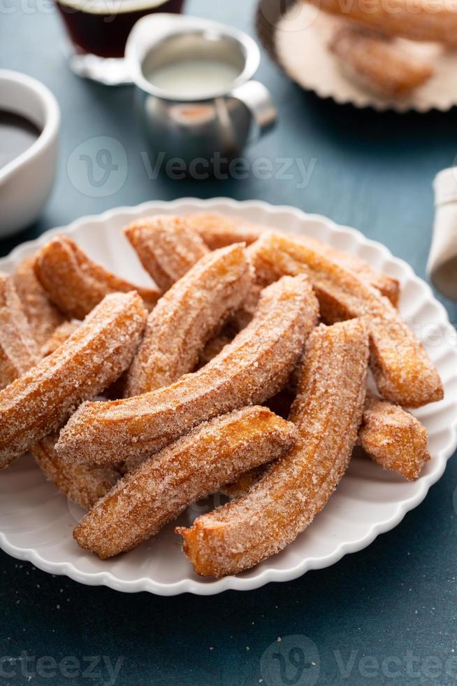 churros faits maison avec du sucre à la cannelle sur une assiette photo