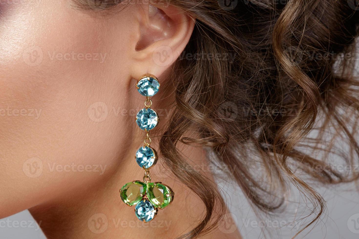 femme portant de belles et chères boucles d'oreilles photo