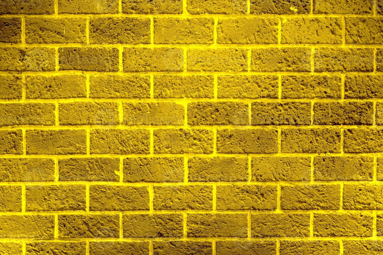 texture de mur de briques dorées brillantes, arrière-plan abstrait, motif doré photo