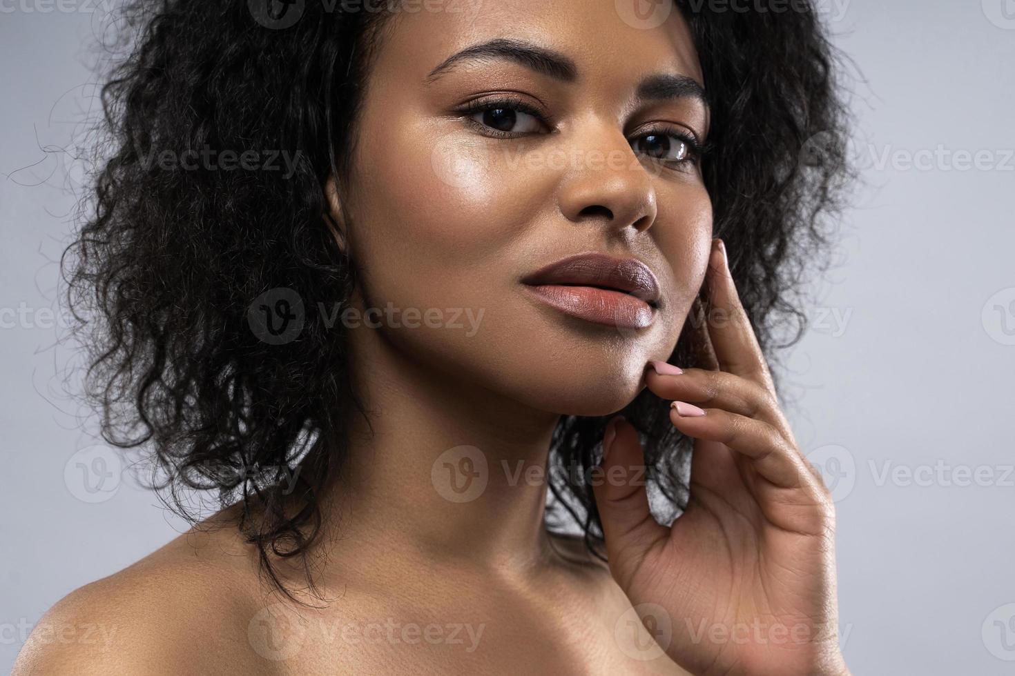 belle femme noire à la peau lisse sur fond gris photo