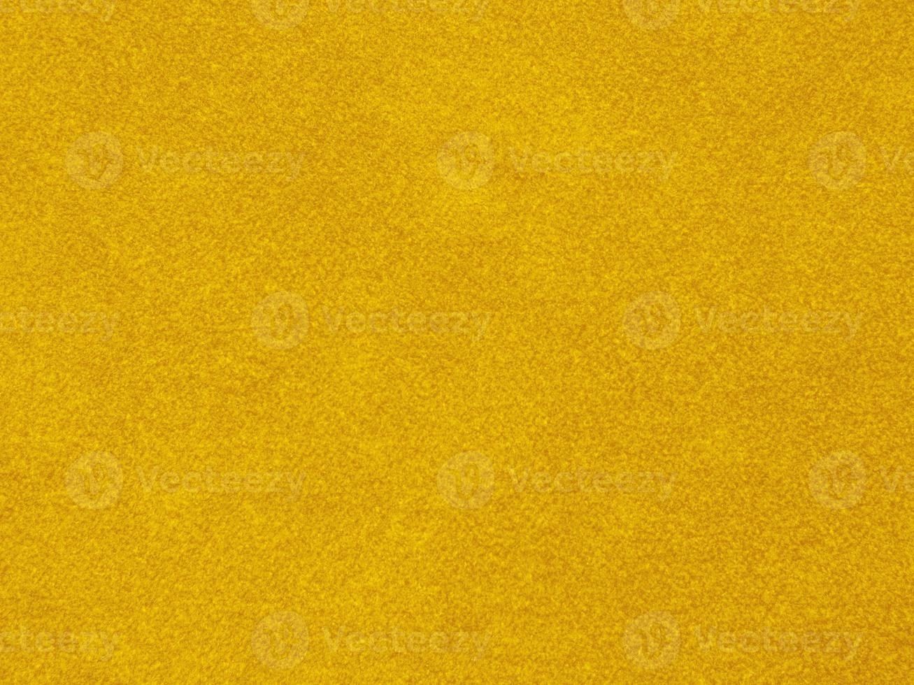 texture de tissu de velours jaune utilisée comme arrière-plan. fond de tissu jaune vide de matière textile douce et lisse. il y a de l'espace pour le texte photo