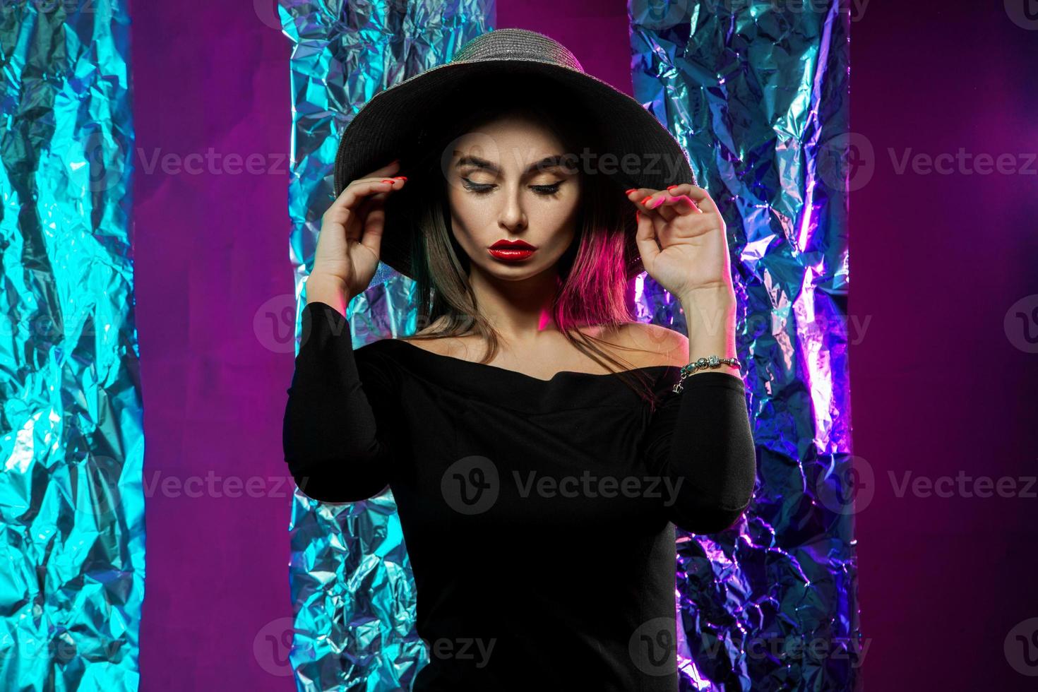 élégante jeune fille en robe noire et chapeau photo