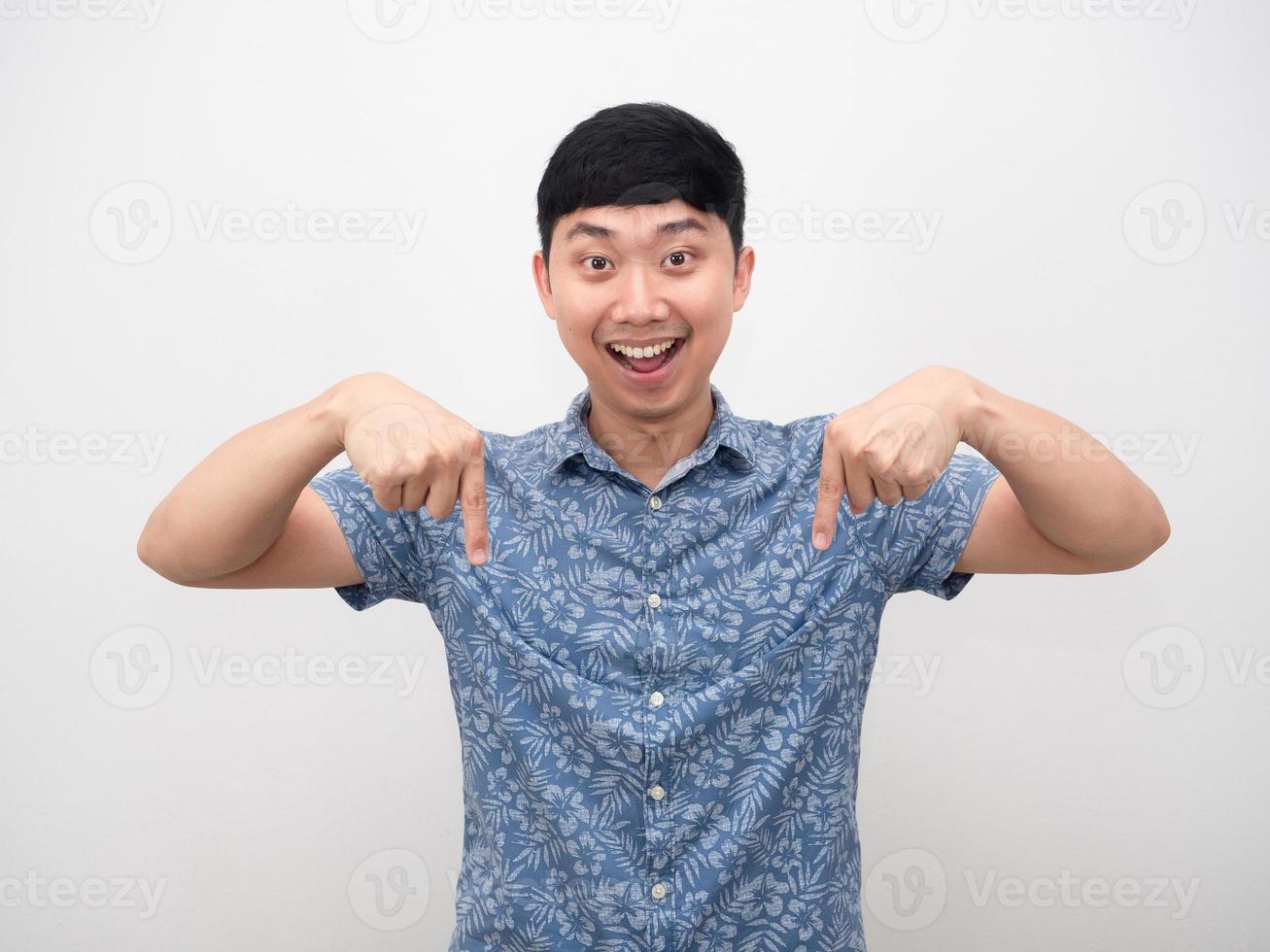 l'homme chemise bleue heureux sourire pointer du doigt vers le bas photo