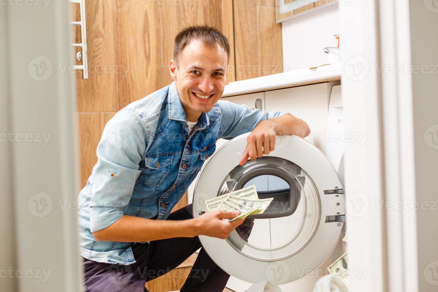 homme chargeant des chiffons dans la machine à laver. vue de l'intérieur de la machine à laver. photo