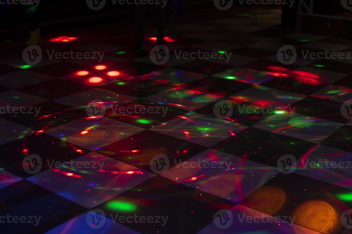 piste de danse disco. lumière sur la piste de danse. taches colorées sur le sol. lumières du projecteur. photo