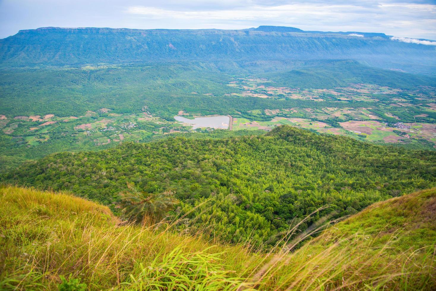 paysage sur la colline avec une prairie d'herbe verte sur le fond de la vue sur la montagne photo