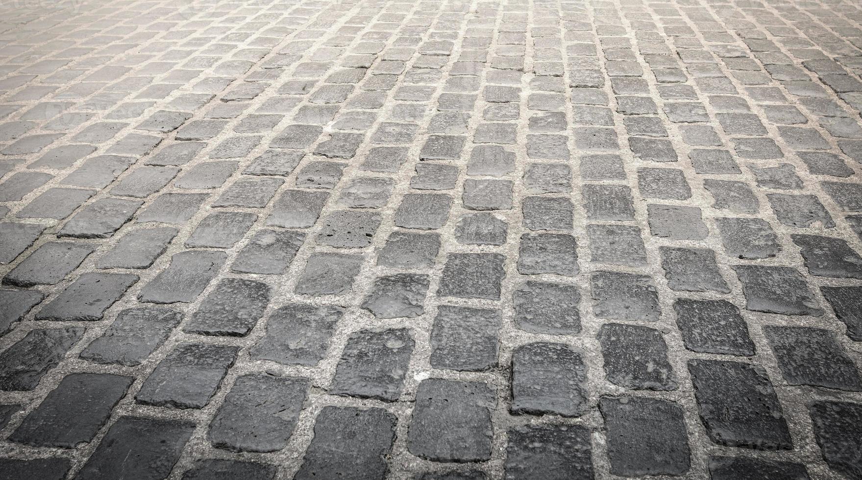 gros plan sur l'arrière-plan de la chaussée pavée de granit. mise au point sélective. photo