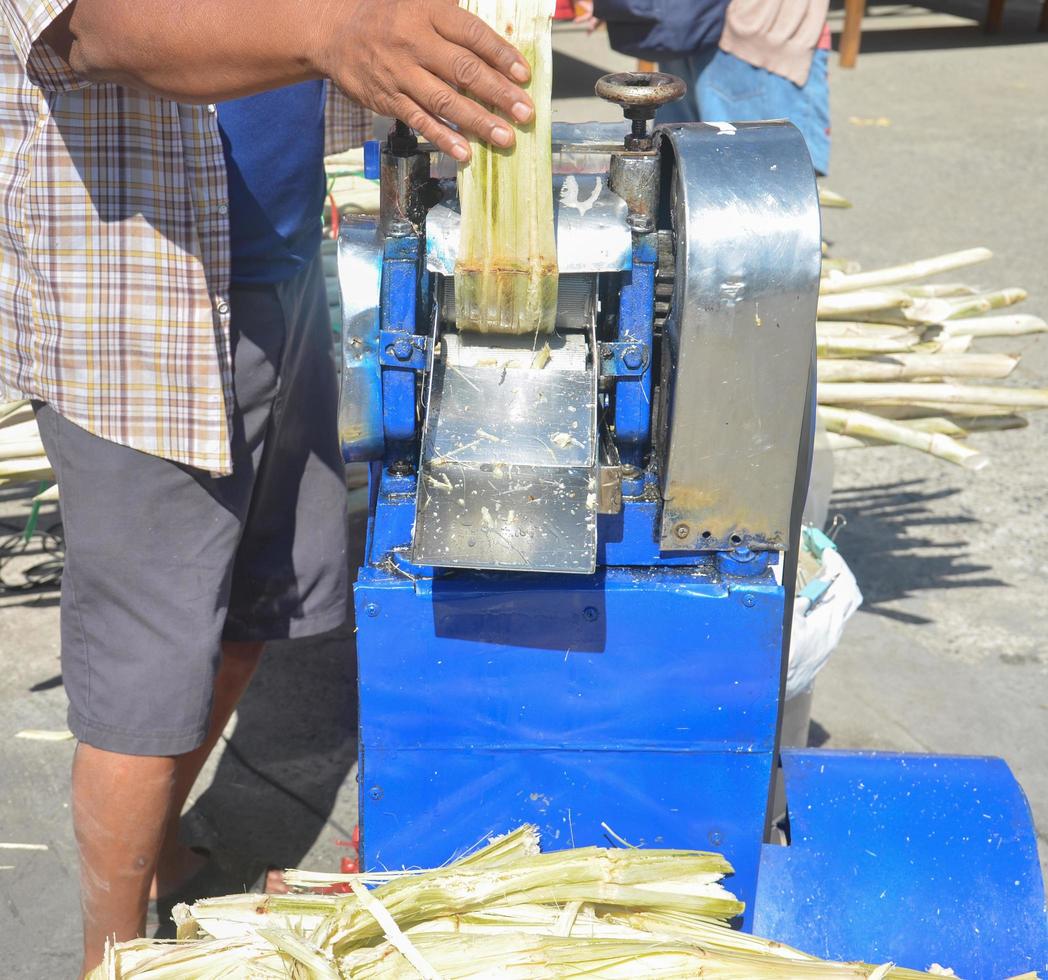fermer de petites machines pour écraser et extraire le jus de la canne à sucre. photo