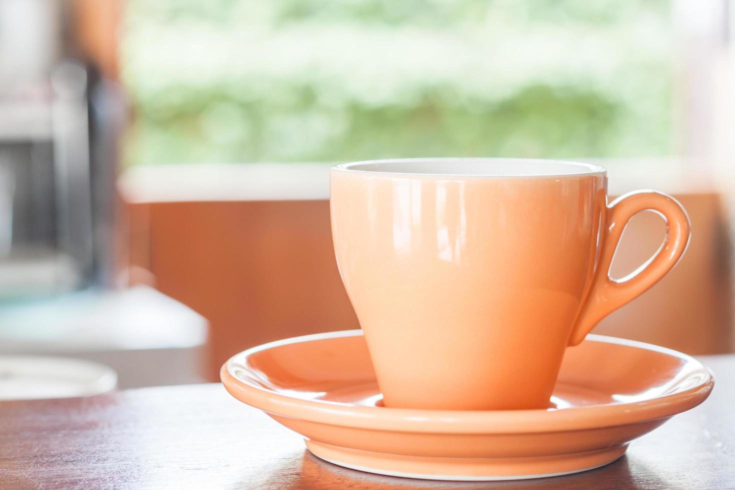 tasse orange sur une table photo