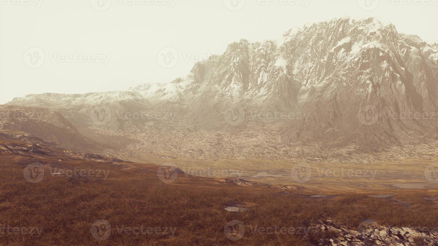 paysage désertique rocheux avec une végétation clairsemée et des sommets de montagnes photo