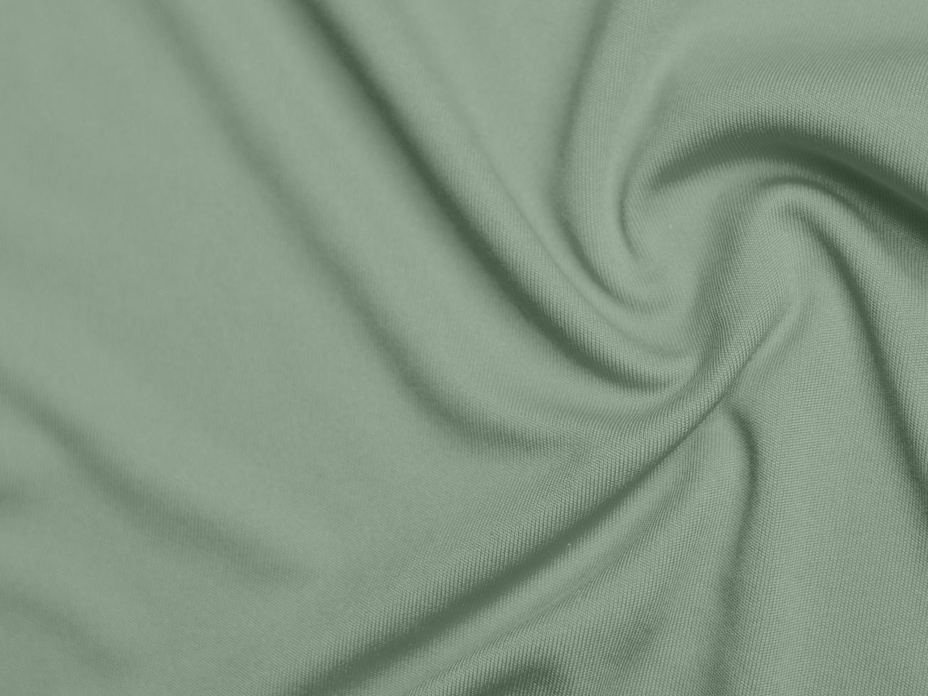 texture de tissu de velours de couleur verte utilisée comme arrière-plan. fond de tissu vert olive clair de matière textile douce et lisse. il y a de l'espace pour le texte. photo