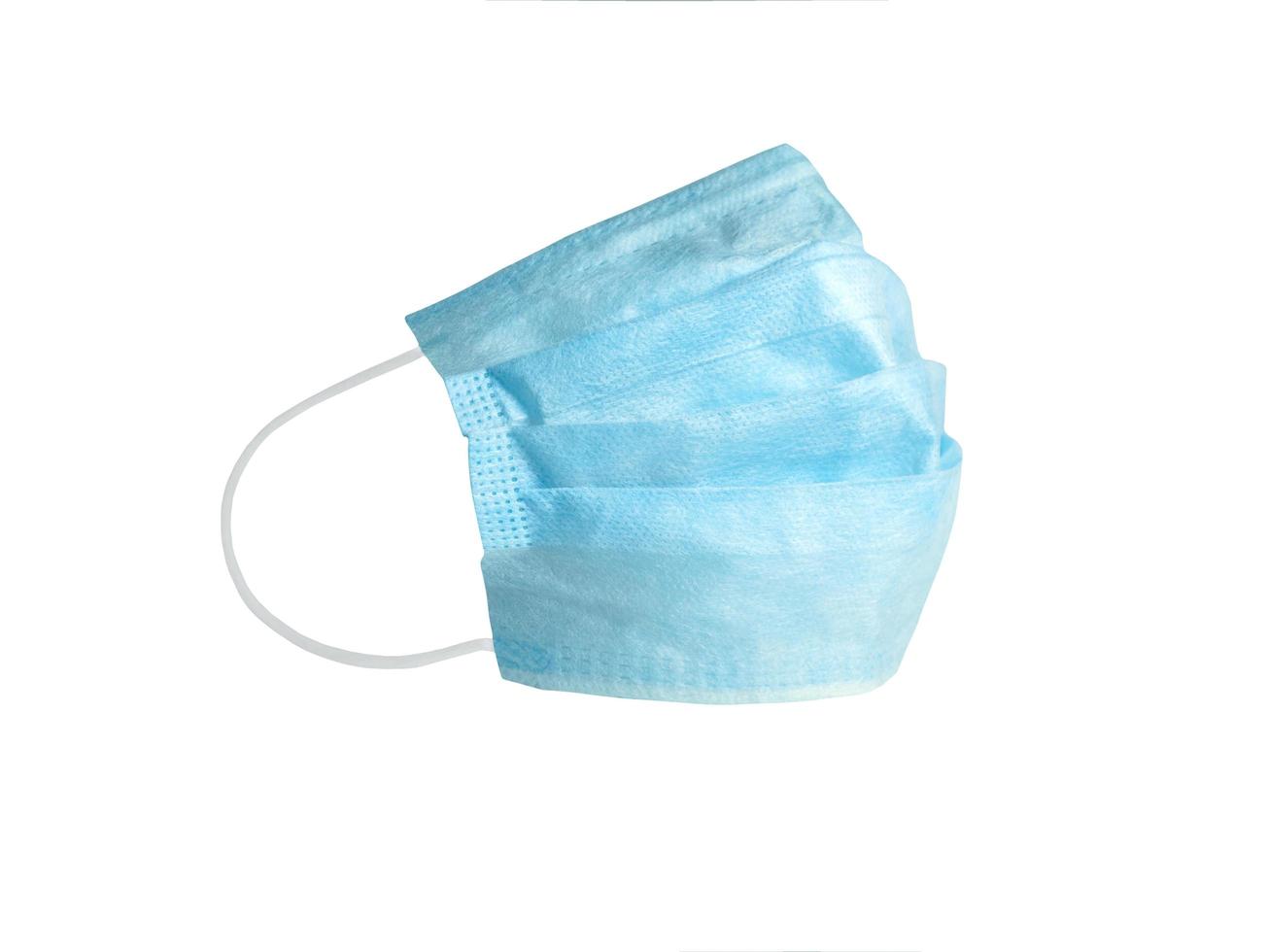 masque respiratoire médical bleu sur fond blanc isolé. pour protéger le médecin des virus, covid-19, contamination photo