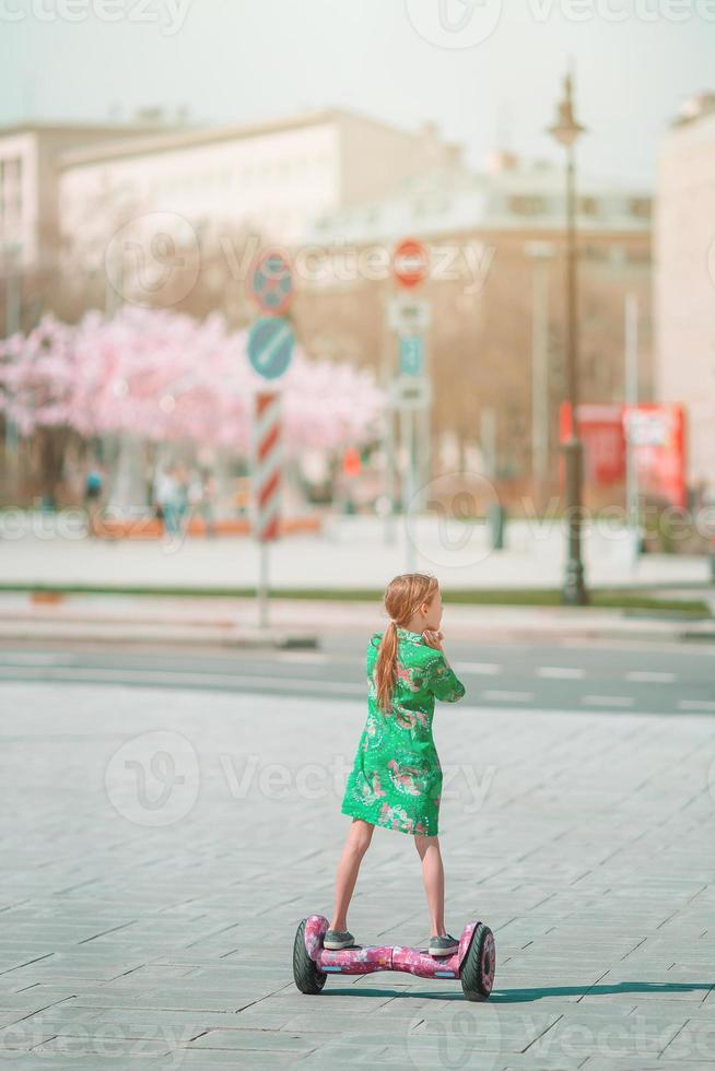 enfant heureux utilisant le transport électrique populaire un scooter gyroscopique auto-équilibré photo