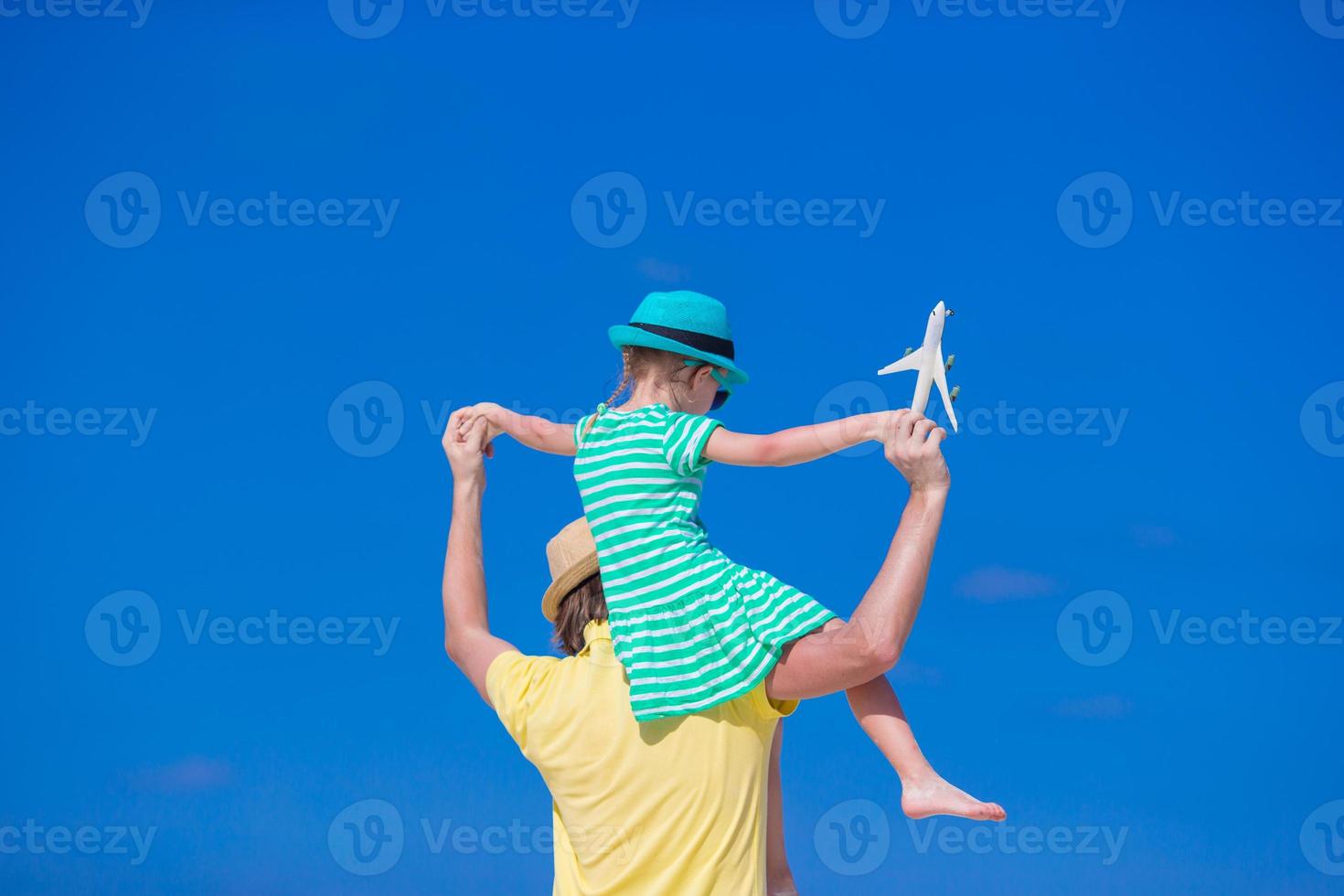 jeune homme et petite fille avec miniature d'avion à la plage photo