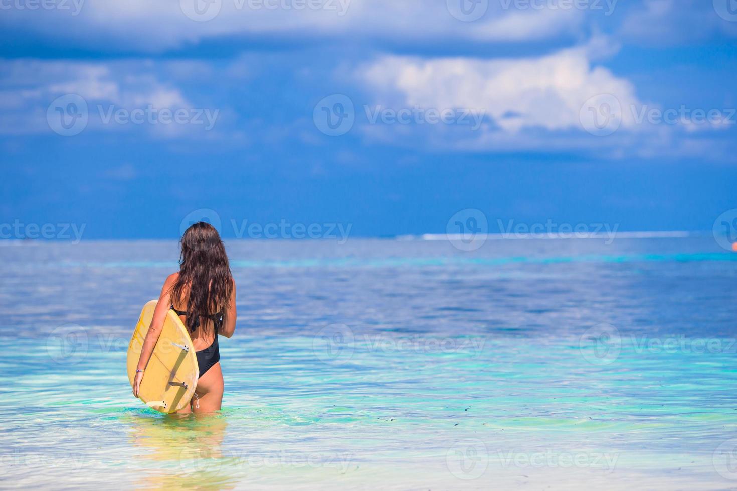 heureux, mince, surf, femme, à, plage blanche, à, jaune, planche surf photo