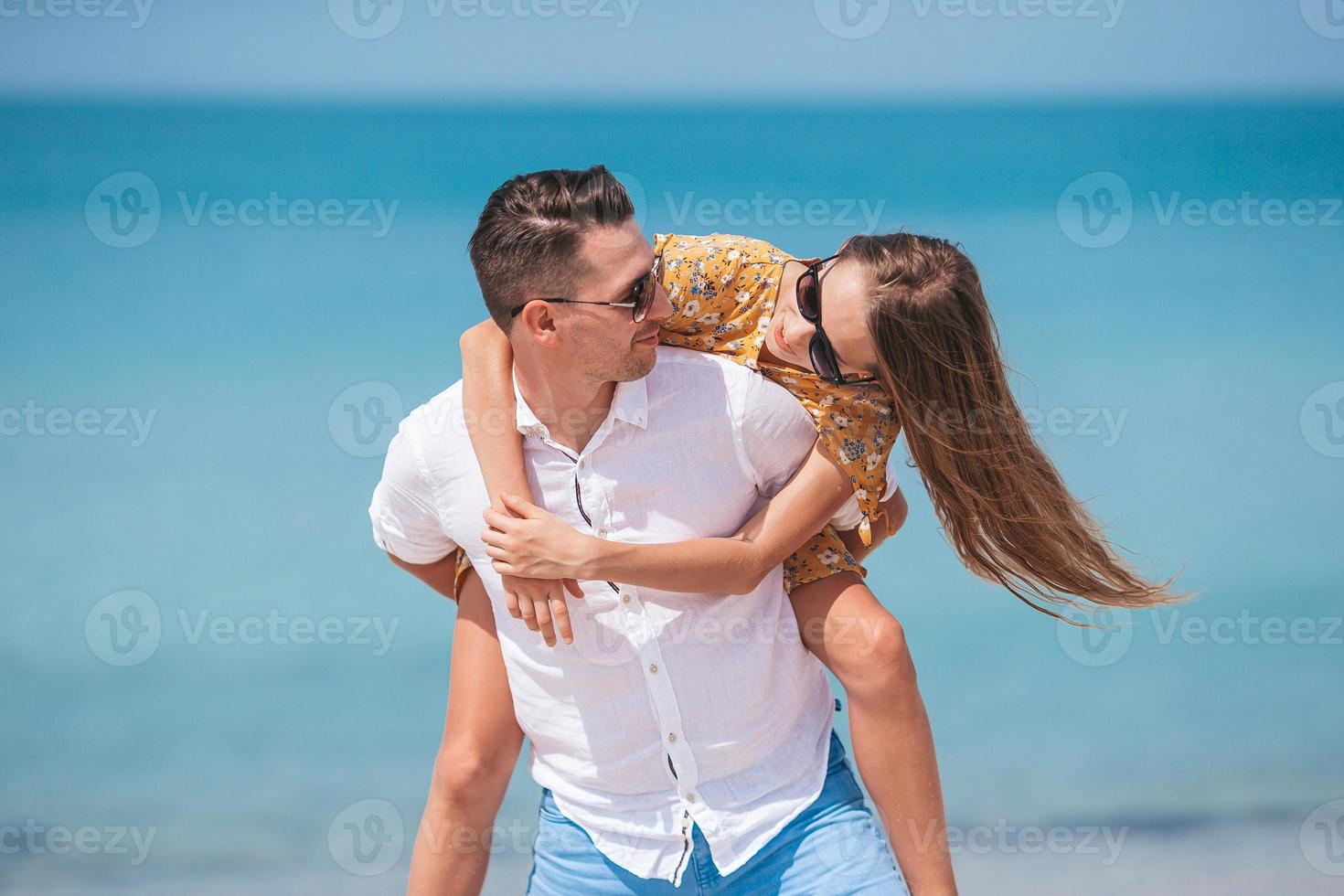 petite fille et papa heureux s'amusant pendant les vacances à la plage photo