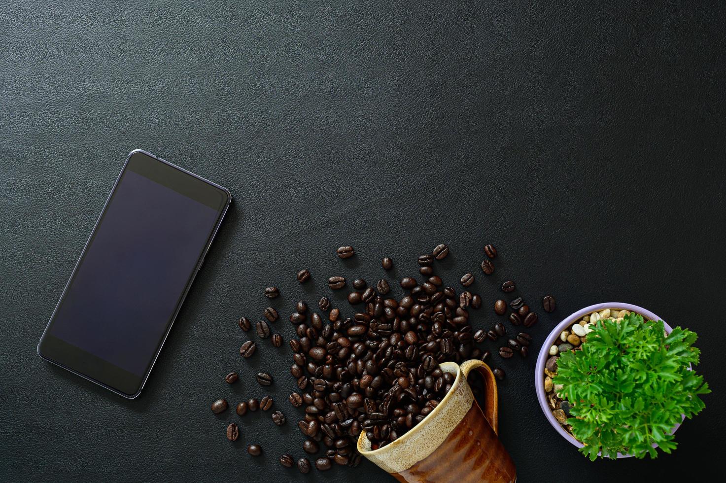 smartphone et grains de café sur le bureau, vue du dessus photo