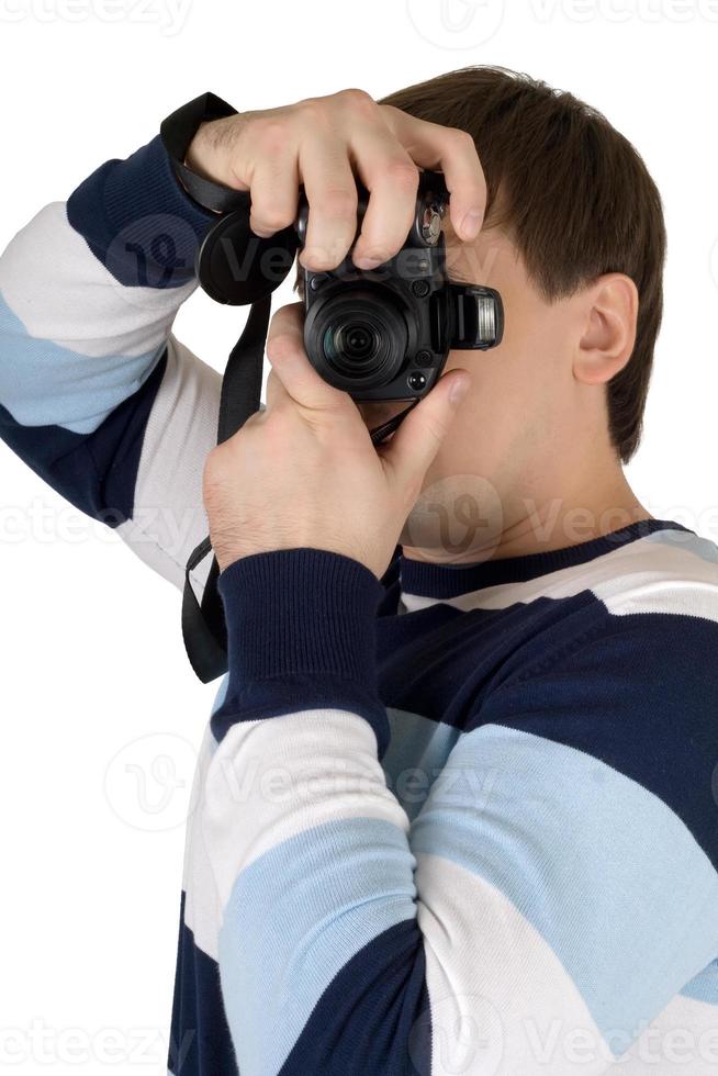 jeune homme avec un appareil photo numérique. isolé sur blanc