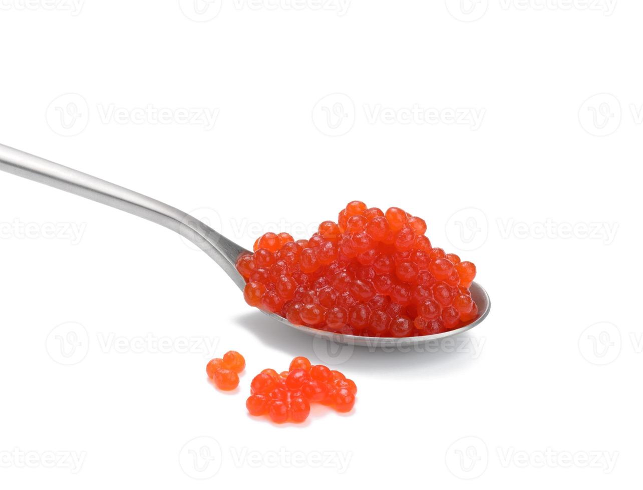Caviar de saumon kéta rouge à grain frais en cuillère métallique, fond blanc photo