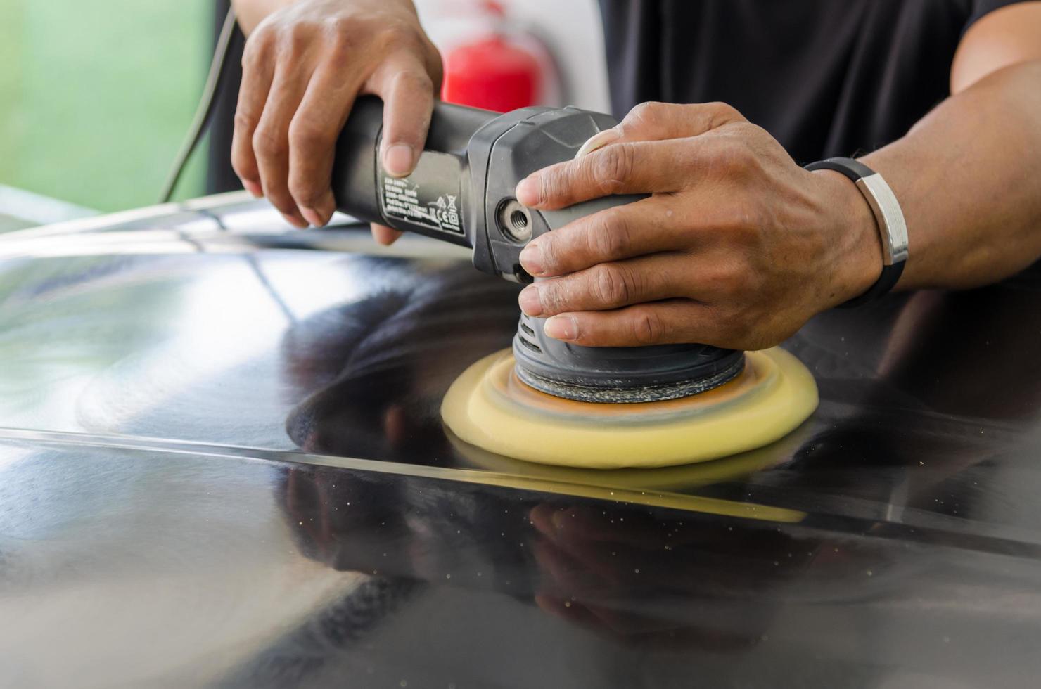 mécanicien polissant une voiture photo