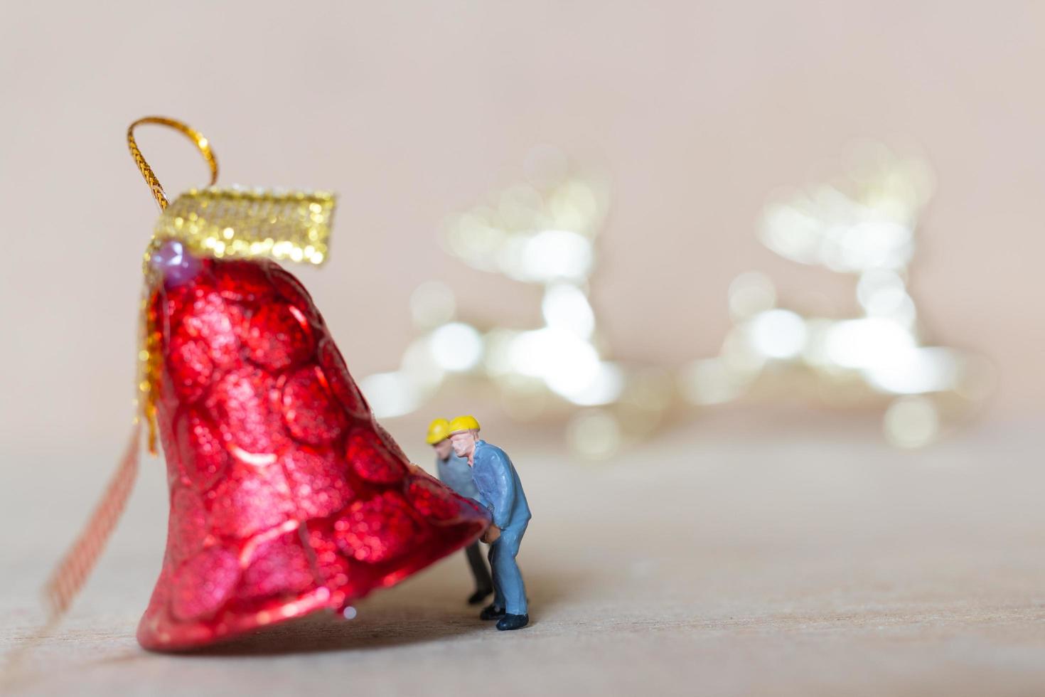 figurines miniatures de personnes installant des décorations de Noël photo