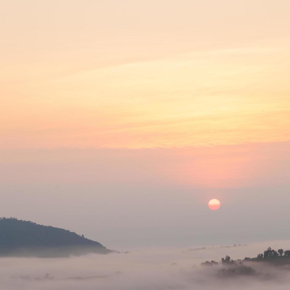 lever de soleil et montagnes couvertes de brume photo