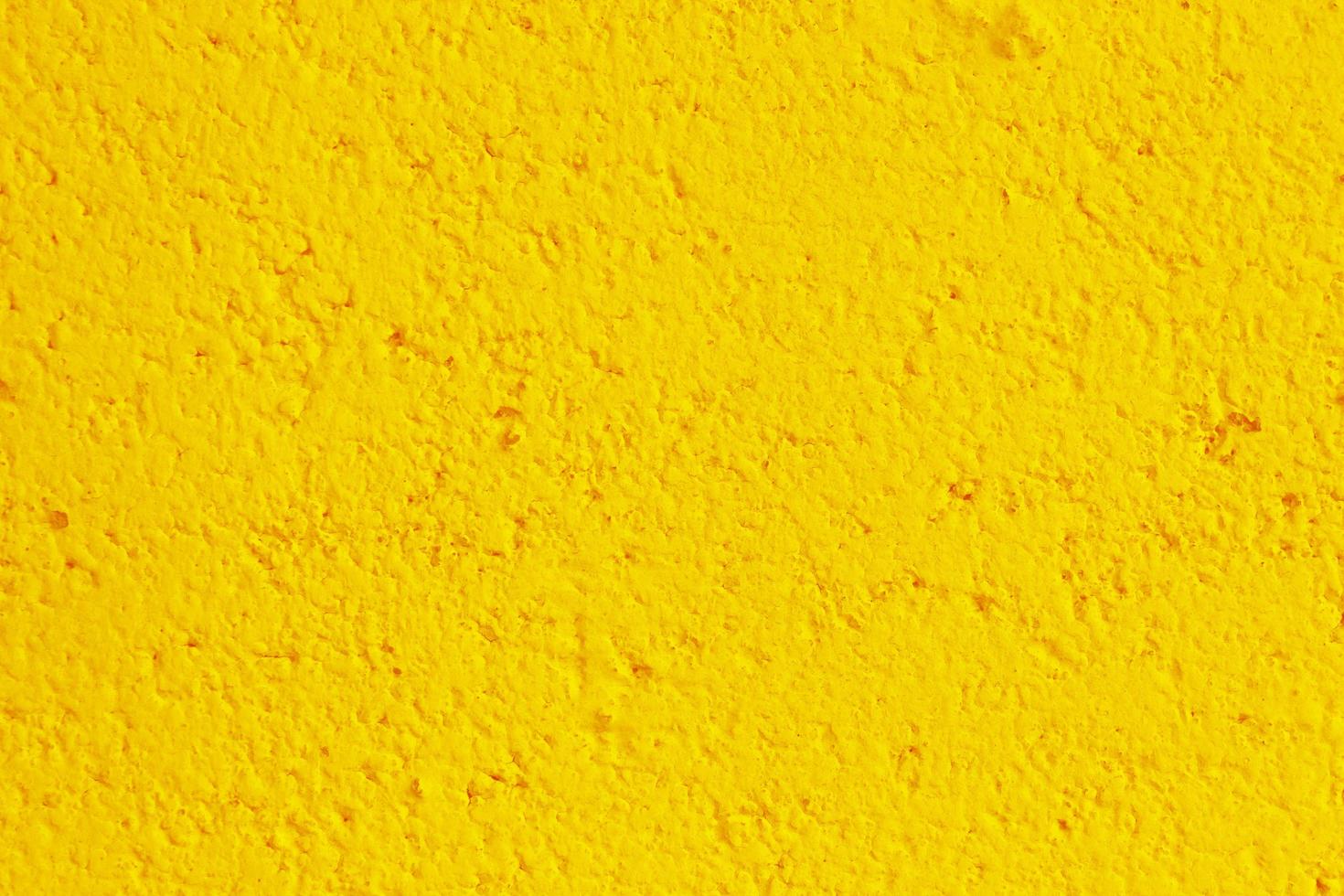 Mur de béton ou de ciment jaune pour la texture ou l'arrière-plan photo