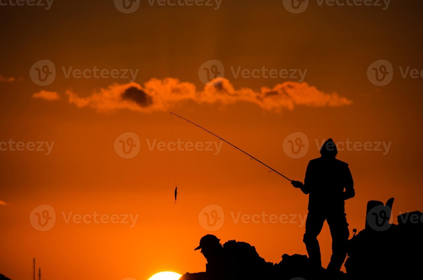 silhouette de canne à pêche pêcheur photo