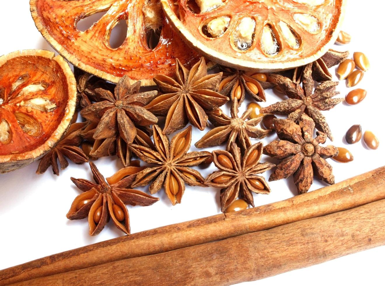 Bâtons de cannelle, étoiles d'anis et coings séchés sur blanc photo