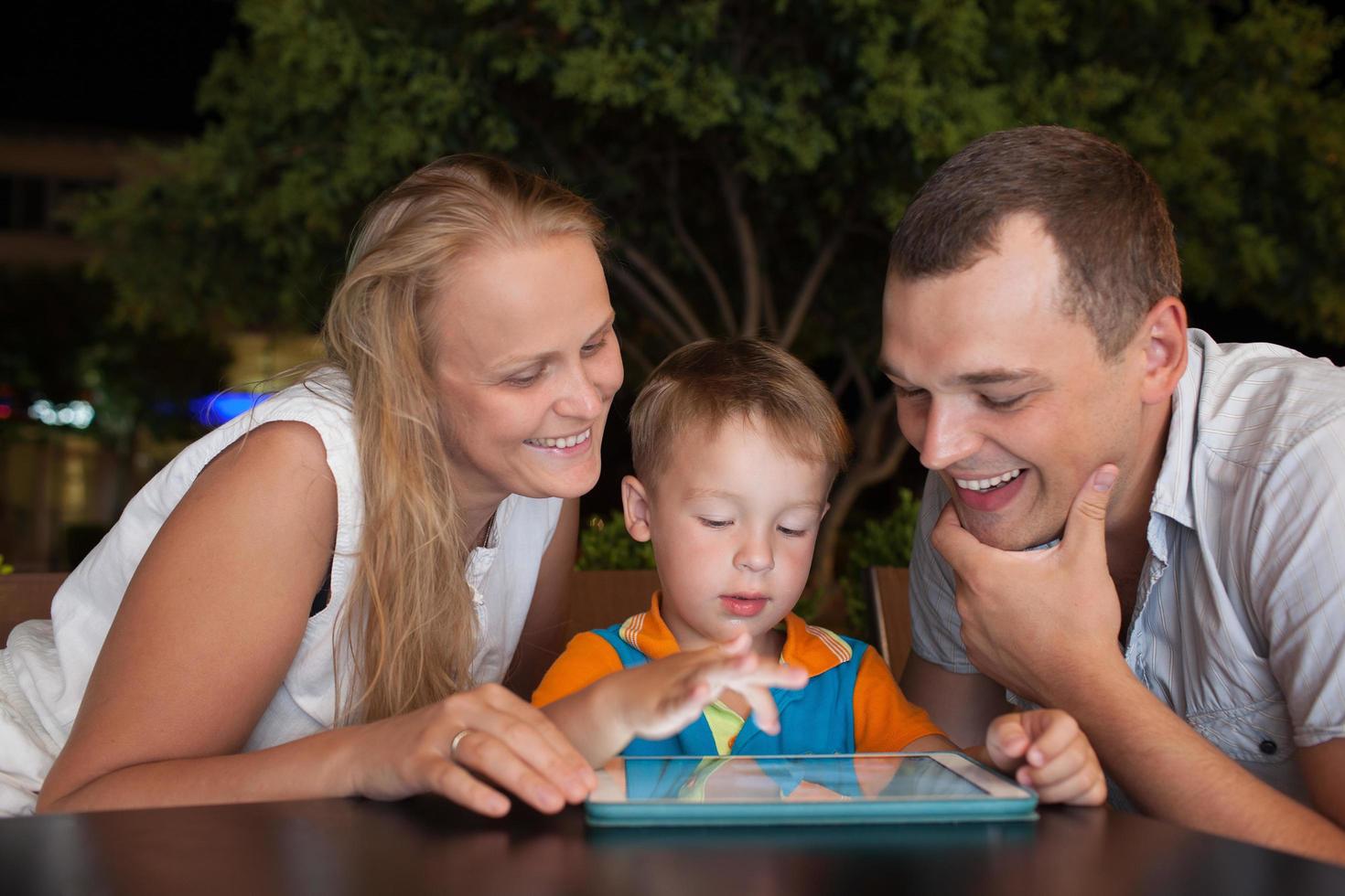 famille avec une tablette à l'extérieur photo