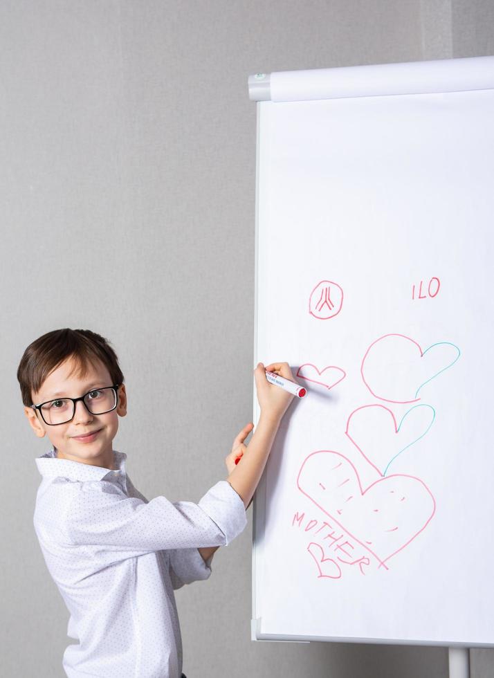 européen blanc garçon permanent près école planche pour présentation. éducation, enfance, devoirs et école concept. photo