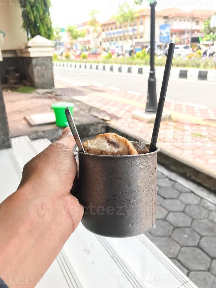 porter une verre de plaine pain plongé dans glacé Chocolat photo